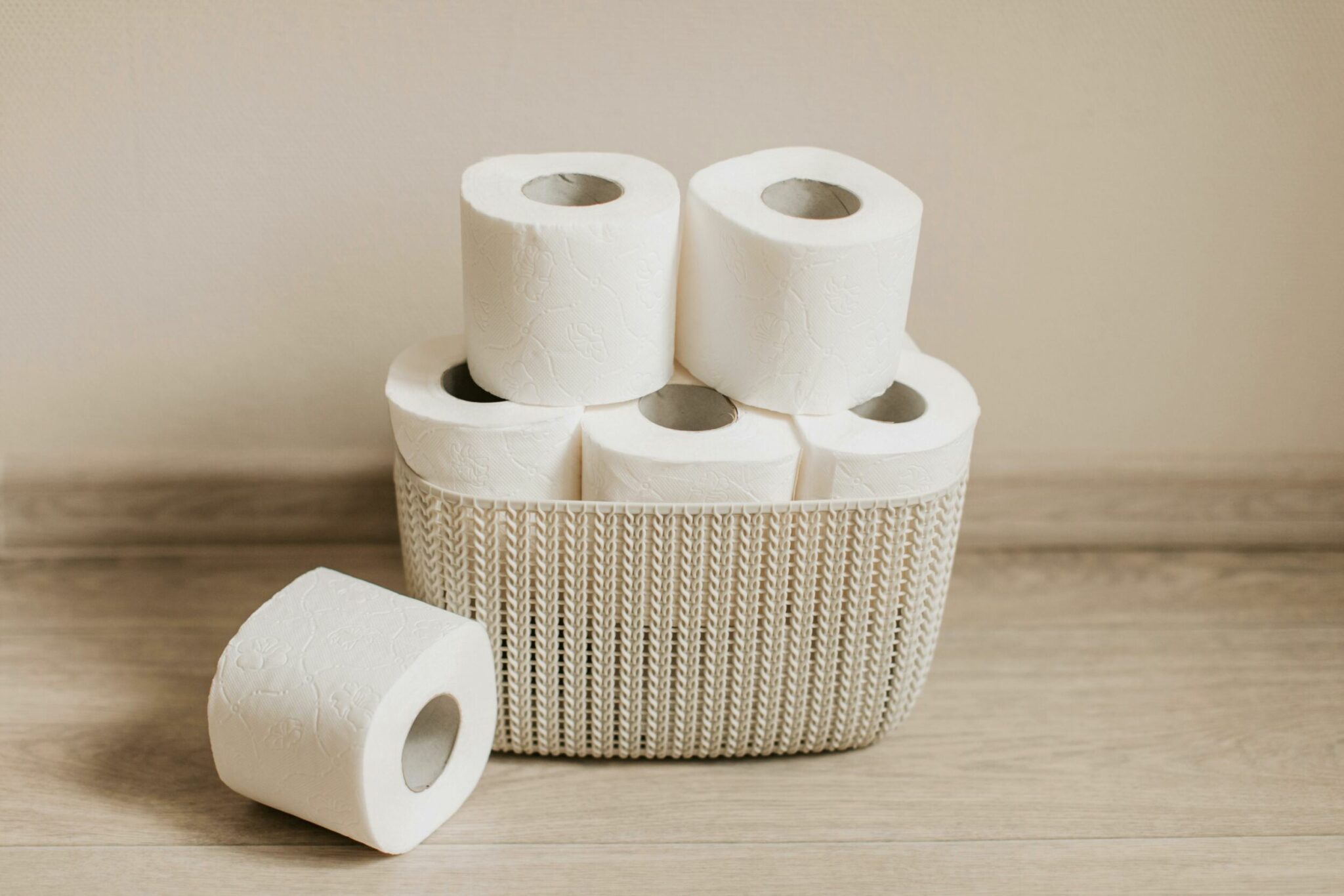 A stack of toilet paper in a basket